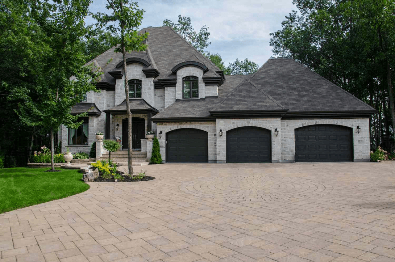 House photo after enhance — sharp brick pavers, stone, and leaves recovered