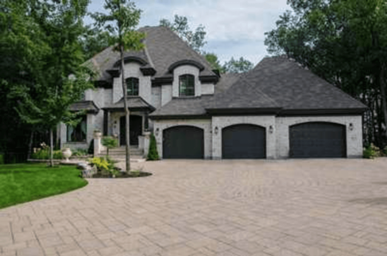 House photo before enhance — heavily pixelated, low detail in brick and foliage